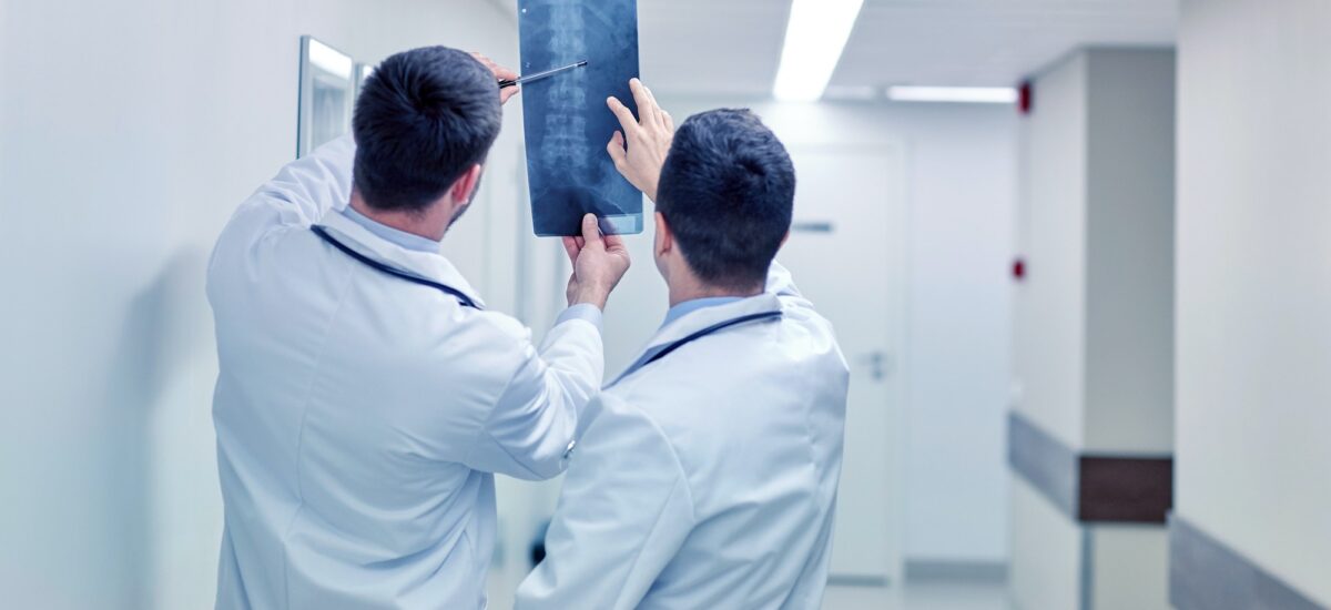 medics with spine x-ray scan at hospital